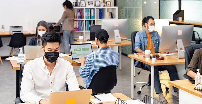 Employees social distancing in office